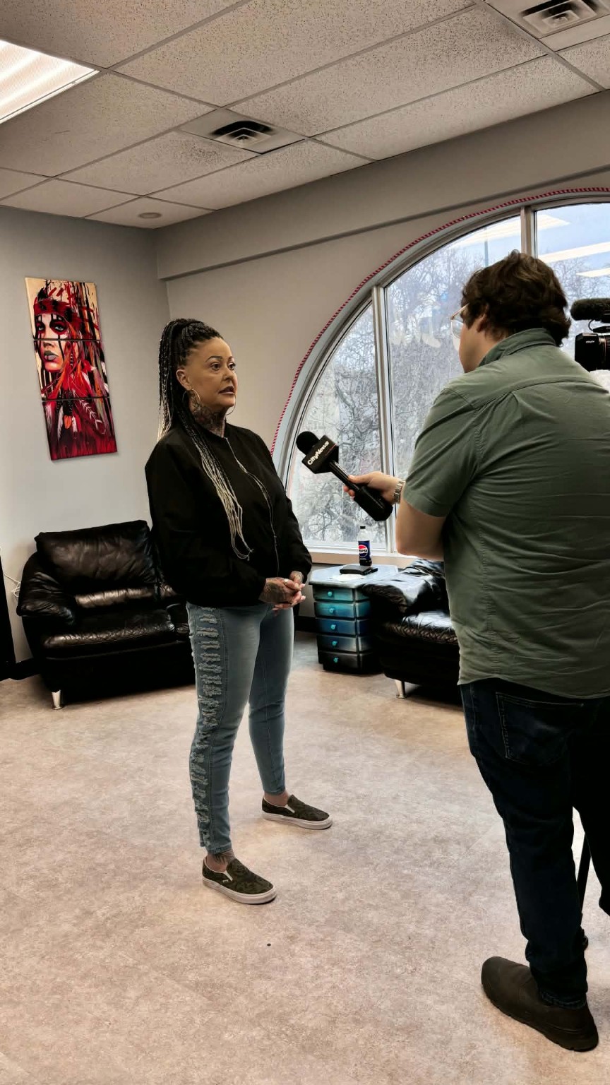 Della Steinke speaking with media inside the Mother Ink studio