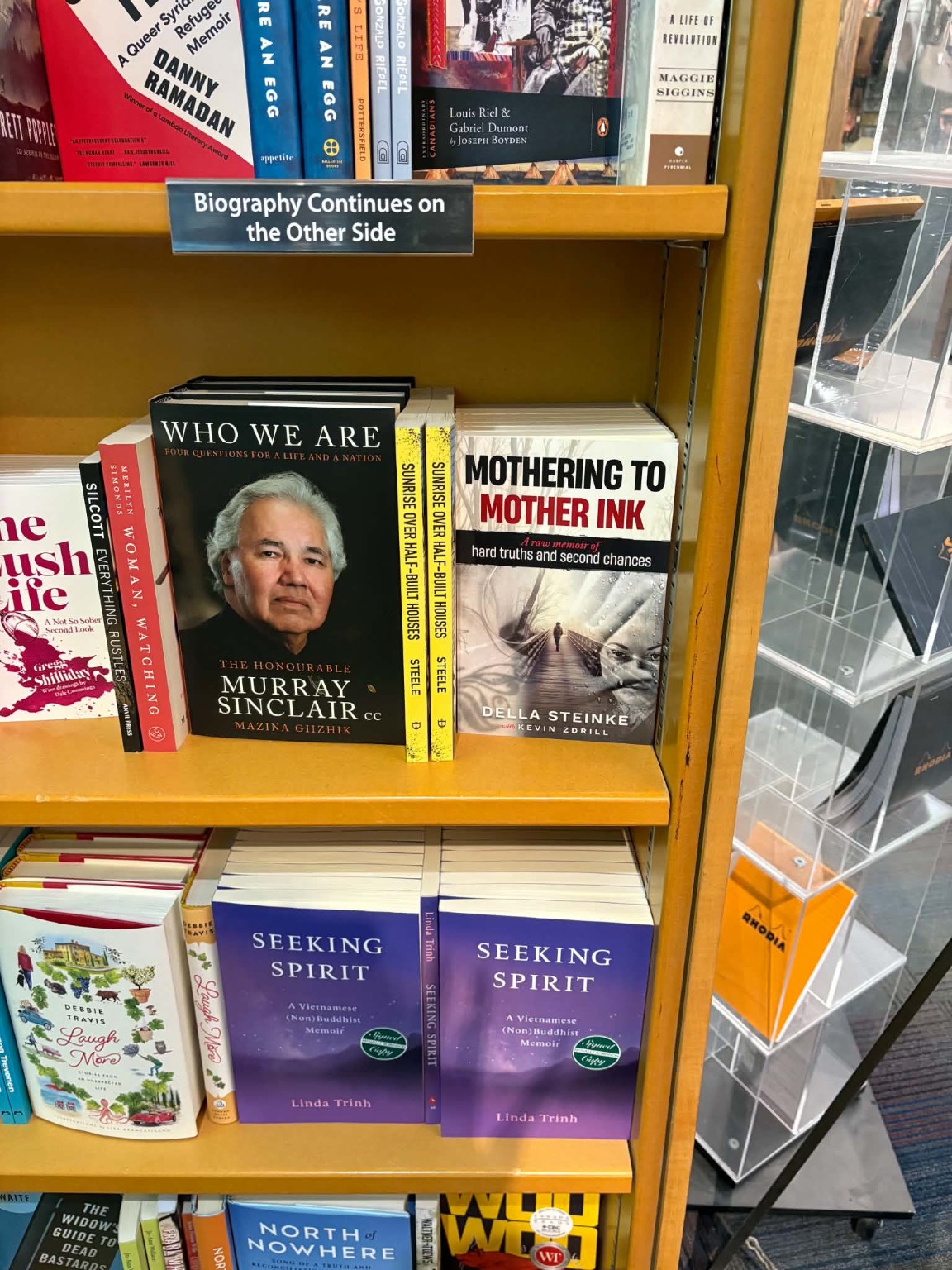 Copies of Mothering to Mother Ink displayed on a bookstore shelf