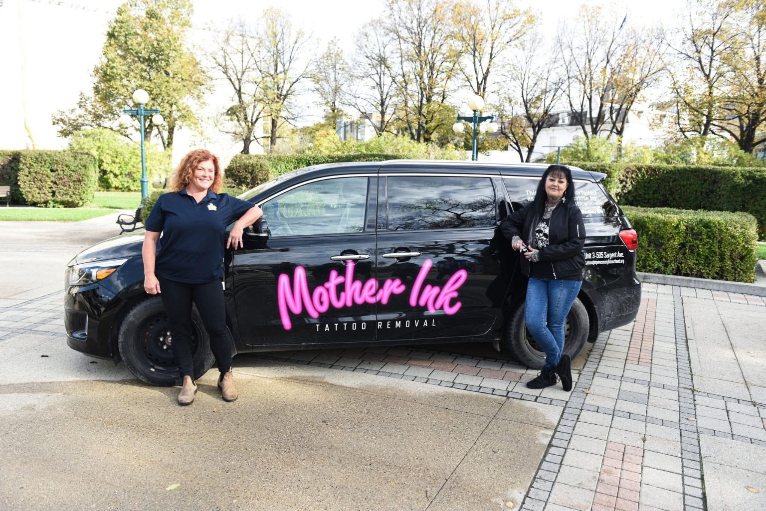 Della Steinke and a Mother Ink colleague beside the branded outreach van